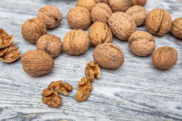 a scattering of walnuts on a wooden background close-up