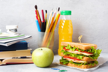 Healthy lunch for school with sandwich, fresh apple and orange juice. Assorted colorful school...