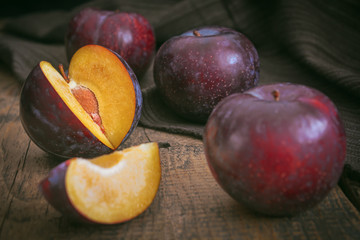Fototapeta na wymiar Red cherry plum fruit on wooden table background.