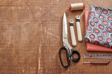 Accessories for sewing and fabric on a wooden surface