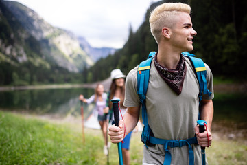 Trekking, camping, hiking and wild life concept. Group of friends are hiking in nature