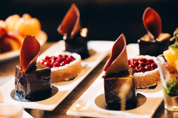 Beautiful cake covered with icing cream, summer berries on the top. Style and food photography