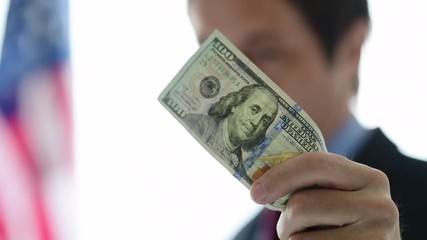 American businessman holding hundred dollar bill
