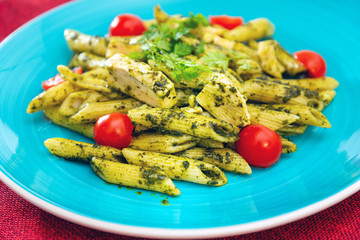 close-up of plate of pasta and chicken with lettuce