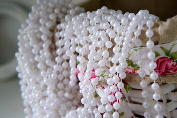 Still life of wicker basket and beads.