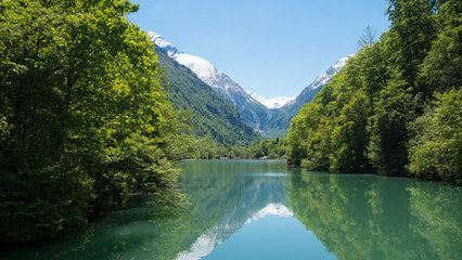 Fototapeta na wymiar Austrian lake with reflection of snowy mountain behind