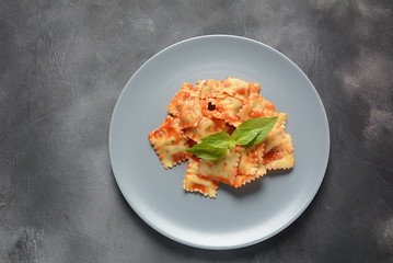 Ravioli with tomato sauce and basil, italian cuisine