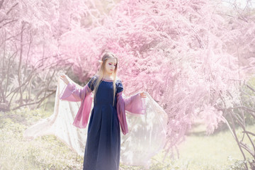 fairy tale girl. Portrait of mystic elf girl. Cosplay character. Portrait of elf in a blooming...