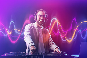 Male DJ playing music in club