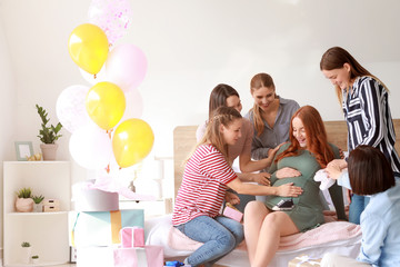 Beautiful pregnant woman and her friends at baby shower party - obrazy, fototapety, plakaty