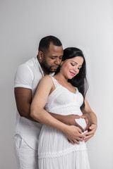 Black man embracing pregnant woman