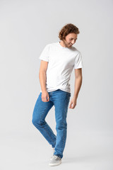 Stylish young man in jeans on white background
