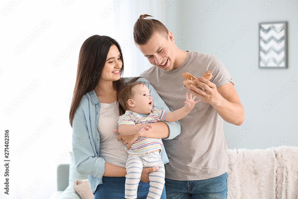 Wall mural Happy parents with cute little baby at home - Wall murals