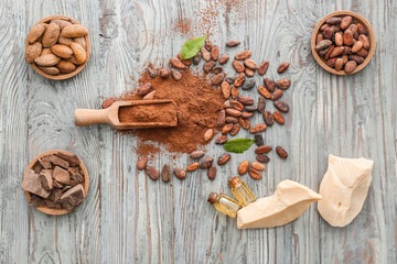 Different cocoa products on wooden background