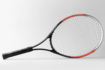 Tennis racket on grey background