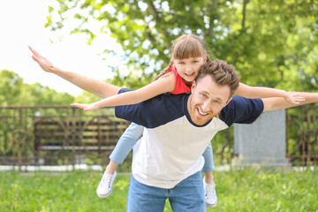Obraz premium Portrait of happy father and his little daughter outdoors