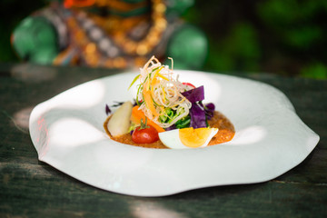 Gado-gado, traditional indonesian food. Salad of slightly boiled vegetables and hard-boiled eggs served with with peanut sauce 
