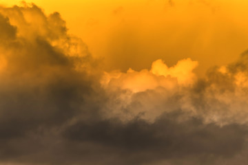 Twilight sky with effect of light pastel orange colors. Colorful sunset of soft clouds.