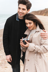 Happy young couple wearing autumn coats