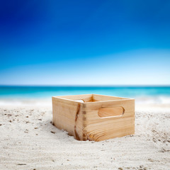 Fototapeta na wymiar Wooden empty container with free space for your product. The possibility of mounting bottles with drink, ice cream, food or other products. Blurry beach with people and ocean view.
