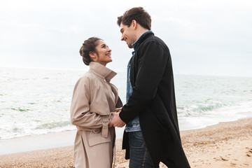 Happy young couple wearing autumn coats