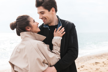 Happy young couple wearing autumn coats