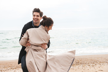Happy young couple wearing autumn coats