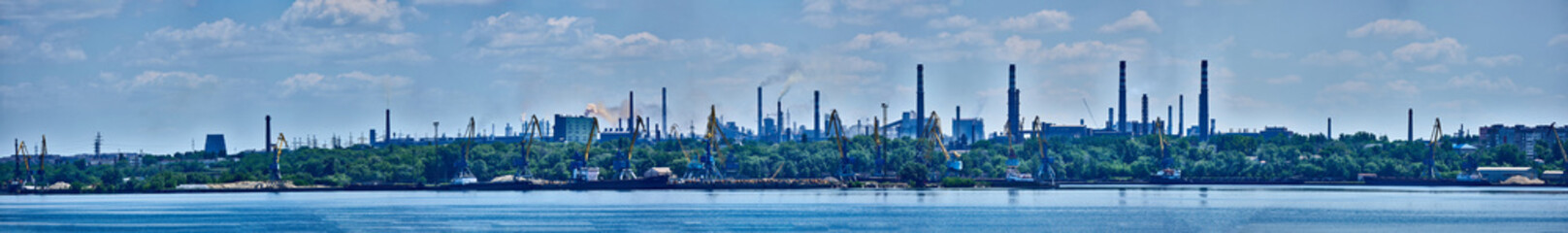 Naklejka premium Panorama of the port and the factory industrial area with many pipes with smoke