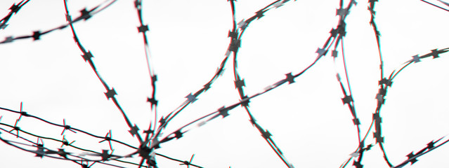 Barbed wire on country border. Barbwire on fence for prohibition of illegal aliens crossing. Glitch...