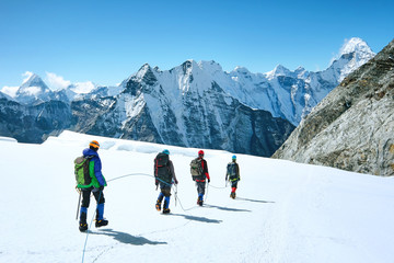 Climbers reaches the summit of mountain peak. Success, freedom and happiness, achievement in...