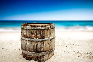 Naklejka premium Wooden barrel on beach and free space for your decoration. 