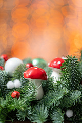 Beautiful festive arrangement of fresh spruce with ball toys in a rustic wooden box. Christmas mood. Bokeh of Garland lights on background.