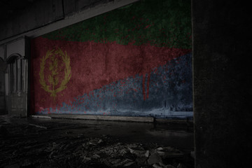 Fototapeta premium painted flag of eritrea on the dirty old wall in an abandoned ruined house.