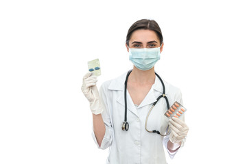 Doctor in mask holding pills in blister isolated on white