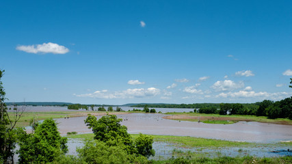 Farm equipment standing in flood water