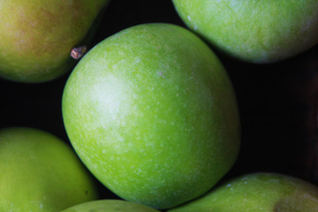 Green apples background in closeup