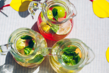 decanters with lemonade apple lemon mint leaves