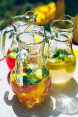 decanters with lemonade apple lemon mint leaves