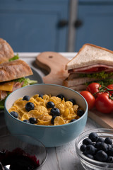 Traditional delicious breakfast. Fresh food. Corn flakes, sandwich, baguette, muffin with dessert. Homemade meal. Kitchen