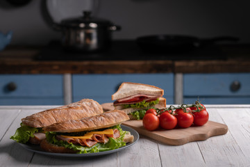 Traditional breakfast. Homemade food. Lunch. Delicious sandwich, baguette, toast. Kitchen. White...