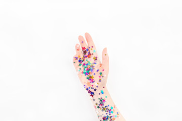 Woman hand with festive color star confetti