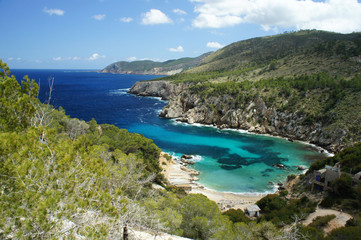 One of the inaccessible bays of the island of Ibiza, Cala d'en Serra, with ruins and a small beach.
