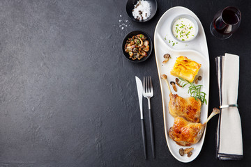 Duck legs confit, potato gratin and mushroom sauce