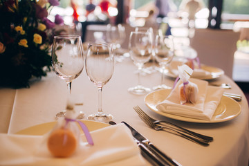 Round white table with elegant compositions from natural flowers. Banquet at the luxury wedding. Elegant design wedding table.