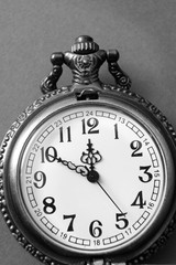 black and white photo of  open pocket watch