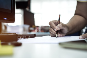 Document report and business busy concept: Businessman manager hands holding pencil for reading and...