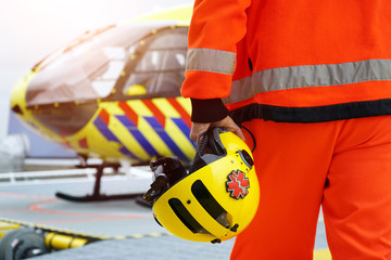 Doctor of an air ambulance in front of a rescue helicopter for an emergency operation