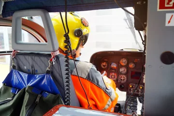 Poster doctor of an air ambulance as a co-pilot on board a rescue helicopter in a emergency operation © Dan Race