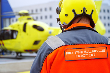 Doctor of an air ambulance runs to a rescue helicopter for an emergency operation