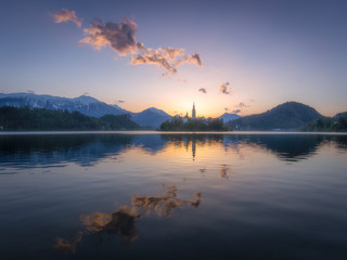 Sunrise at Lake Bled and Assumption of Mary church on the island in center of the lake